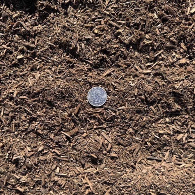 Quarter-inch minus mulch available in bulk for commercial landscape projects.
